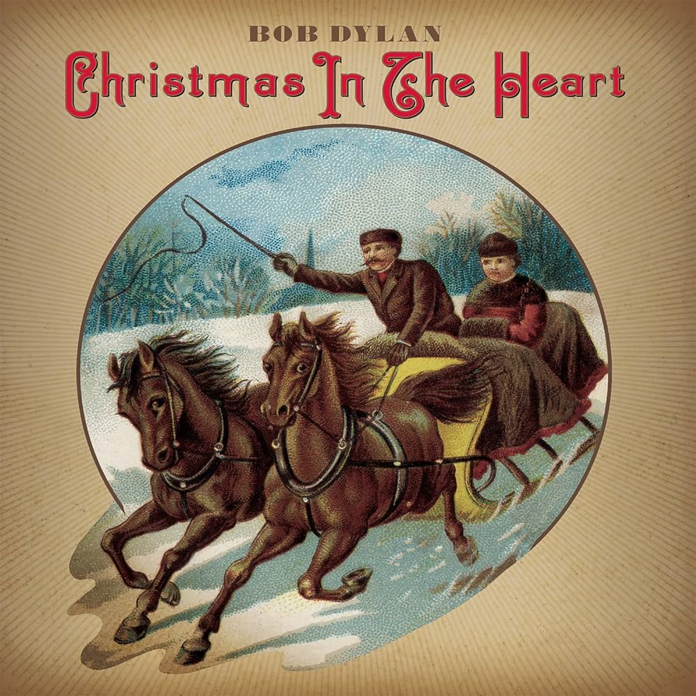 Album cover of "Bob Dylan - Christmas In the Heart" by Tandem Coffee Roasters, featuring a vintage illustration of two people on a horse-drawn sleigh speeding through a snowy landscape with holiday classics.
