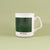 A Maine Mug with a green color block and the text "portland-me" at the bottom, against a light green background by Tandem Coffee Roasters.