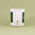 White ceramic 11oz Maine Mug from Tandem Coffee Roasters with green vertical stripes and an embossed handle, featuring a minimalist design and a small logo on a light green background.