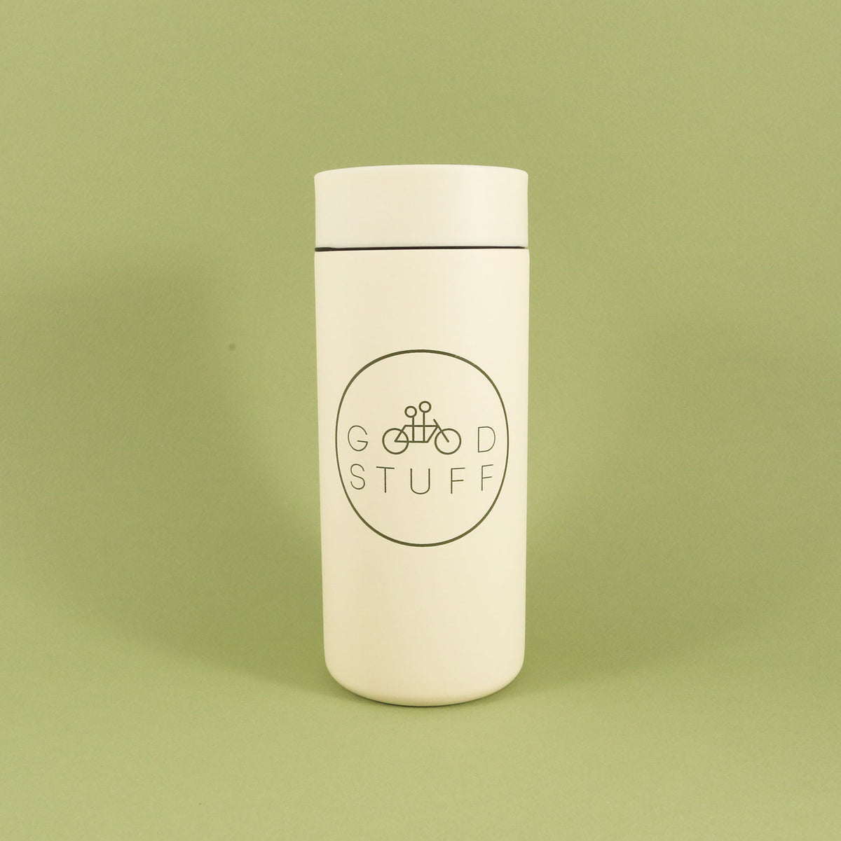 A MiiR 360 Traveler "GOOD STUFF" Mug from Tandem Coffee Roasters, with a logo that reads "good stuff" encircling a bicycle image, set against a solid light green background.