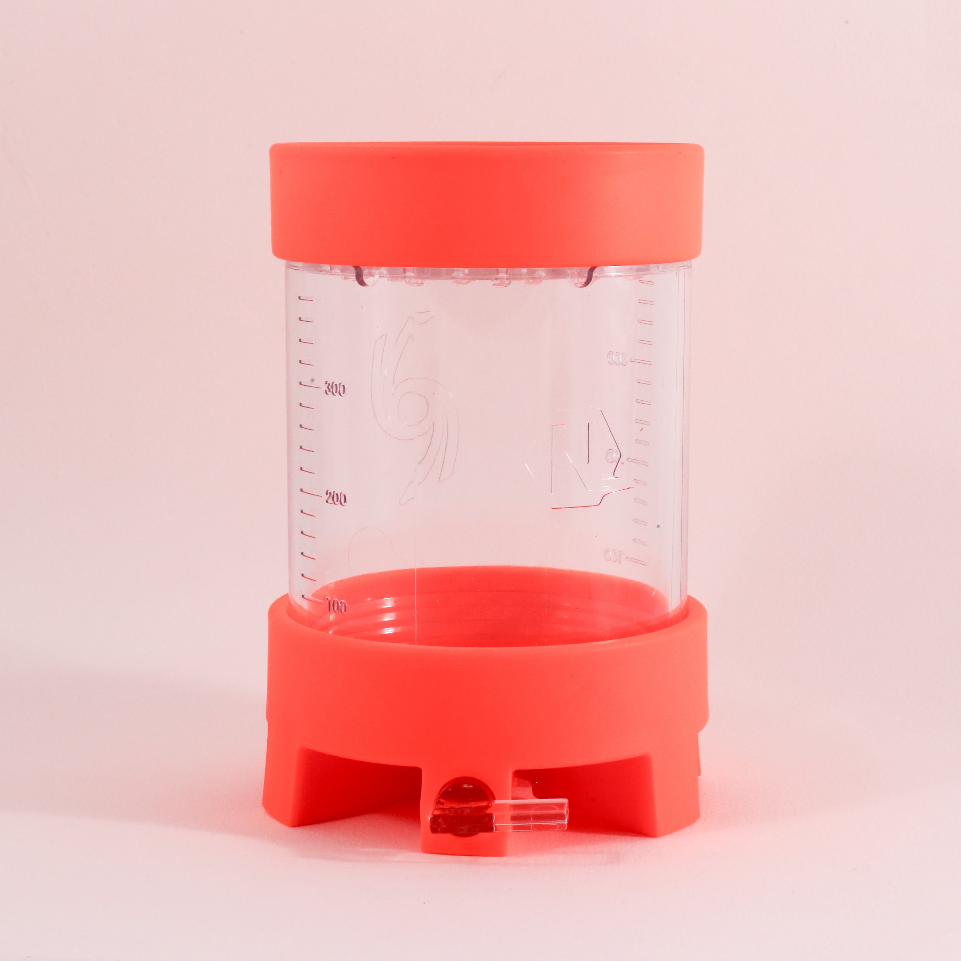 The NextLevel Pulsar Brewer by vendor-unknown is a clear plastic container with red lids on top and bottom, marked up to 300 ml, featuring measurement lines and an adjustable flow valve, shown standing upright on a white background.