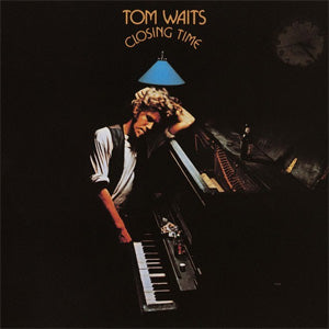 Album cover of "Tom Waits - Closing Time" album by Tandem Coffee Roasters, featuring the artist playing a piano under a blue lampshade, set against a dark background.