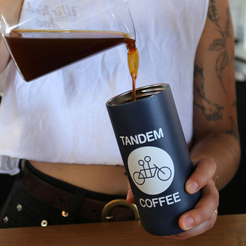 Barista pouring coffee into Tandem Coffee travel mug