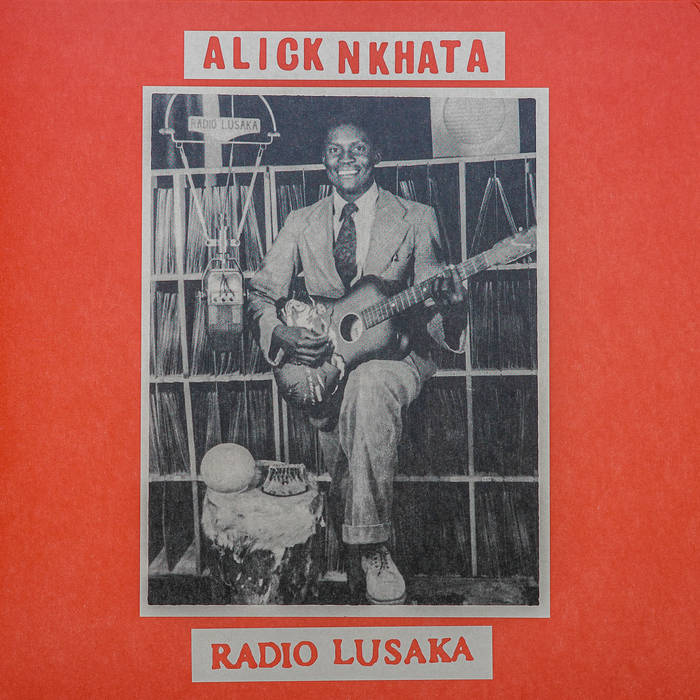 Black-and-white photo of Alick Nkhata with a guitar and cat before record shelves, with “Alick Nkhata - Radio Lusaka” on a red background. Brand: Tandem Coffee Roasters.