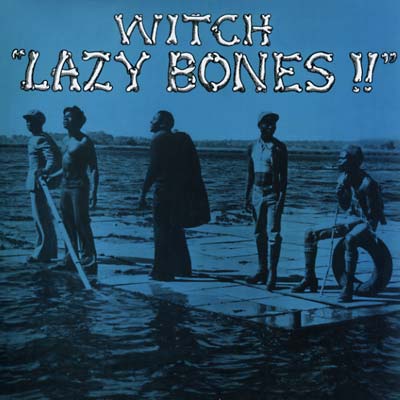 Album cover of "Witch - Lazy Bones" by Tandem Coffee Roasters band, showing members standing on a wooden raft in a shallow body of water, with a blue sky background. The title is displayed in bold white.