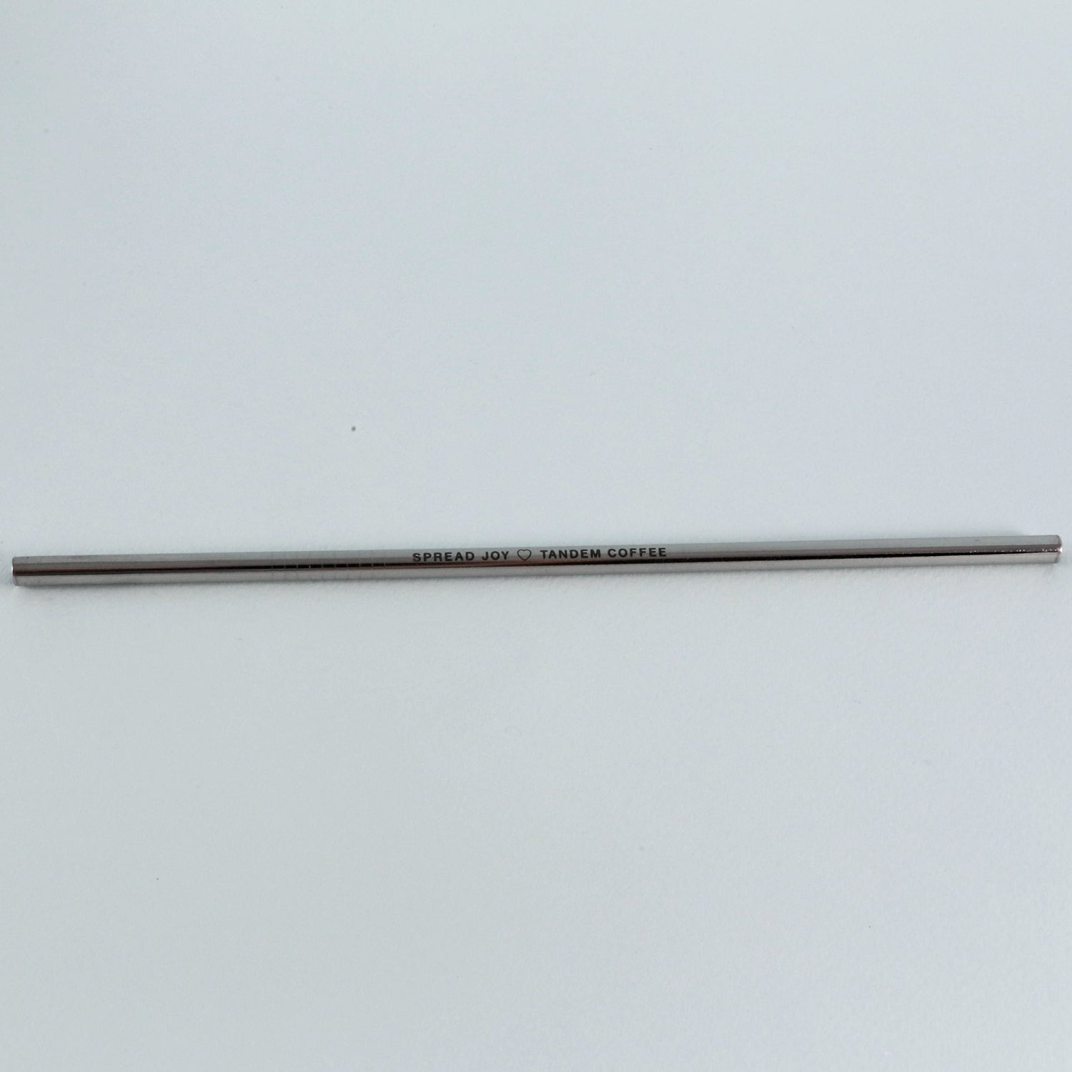A slender, gray pencil with the inscription "Tandem Coffee Roasters Tandem Straw" centered along its side, set against a plain white background.