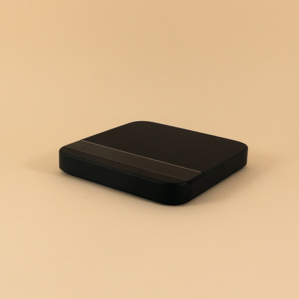 A simple black Tandem external hard drive with high accuracy on a light beige background. The device is rectangular with rounded edges and a slightly textured top surface.