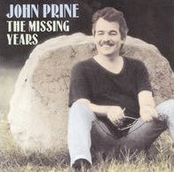 Album cover of "John Prine - The Missing Years" by Tandem Coffee Roasters, featuring him sitting and smiling next to a large rock, wearing a black v-neck and jeans, with Tom Petty.