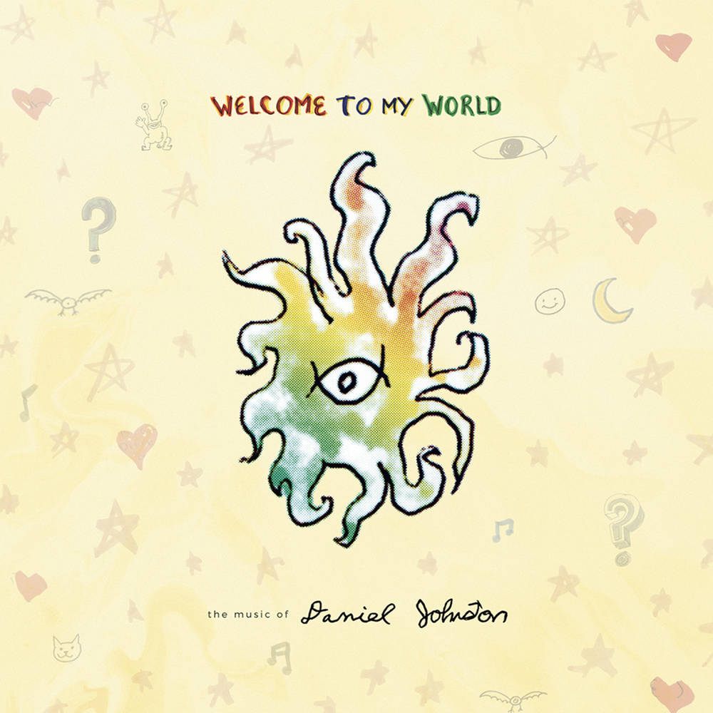 Album cover for "Daniel Johnston - Welcome to My World" by Tandem Coffee Roasters, featuring a whimsical, colorful drawing of an eye in the center of abstract, flame-like shapes on a light yellow background adorned with various.