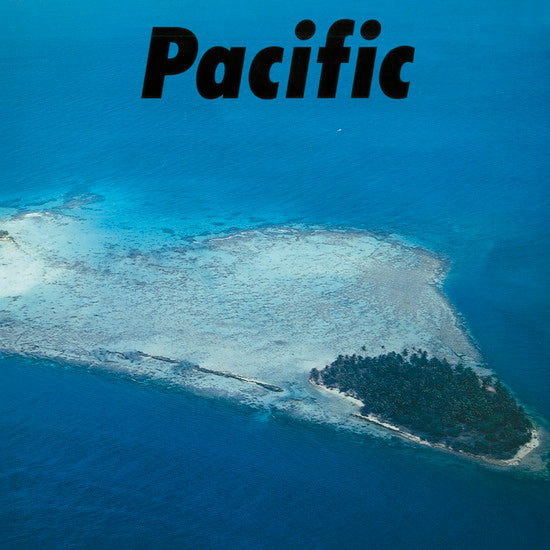 Aerial view of a small tropical island in the Pacific Ocean, featuring a coral reef surrounding the island and the word "Tandem Coffee Roasters" in bold black letters at the top.